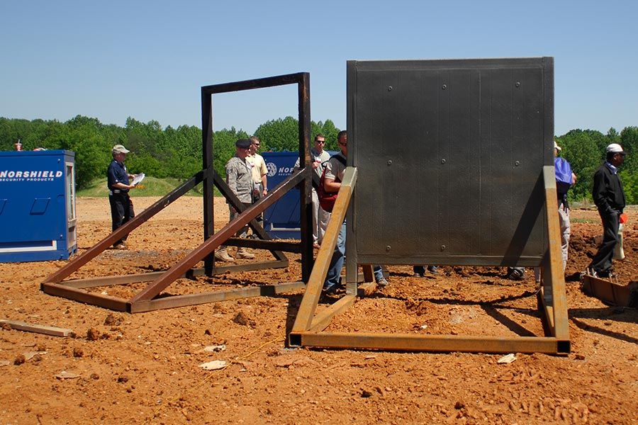 Team preparing full-scale blast test walls on a range